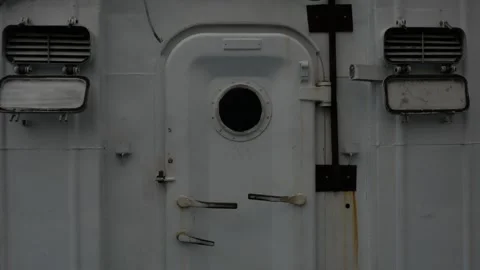 Door in old rusty sea ship. Metal door with round window. Entrance of a sea ship Stock Footage 297750804