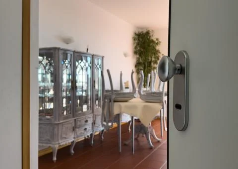 Door open close up view. Retro doorknob on white vintage wooden door, blur .. Stock Photos
