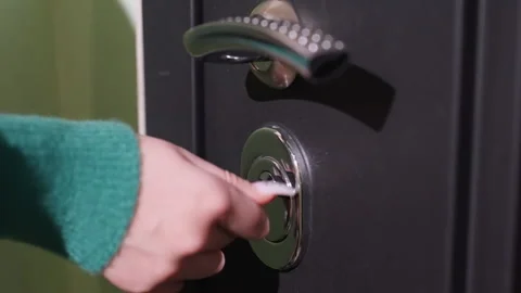Door opening action. Turning key to unlock door. Securing door with strong twist Stock Footage 342054766