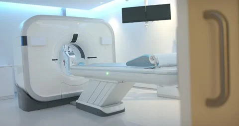 Door opening and camera pulling are showing scanning gantry and table in lab Stock Footage 339414602