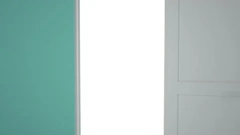 Door opens and a bright light flooding a dark room. Can be used as a concept of  Video stock 167230761