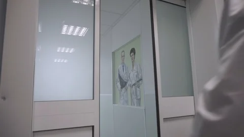 The door opens automatically in front of a doctor Stock Footage 101478360