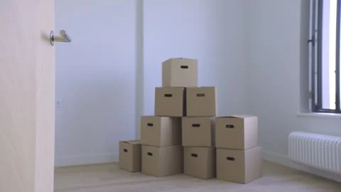 Door Opens to Bright Empty Room with Boxes Stock Footage 313348569