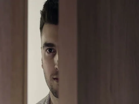 The door opens. The face of a handsome young man with a grin. Stock Footage 74831498