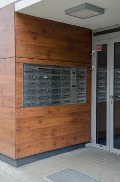 Door Phone Panel with Multiple Mail boxes at Building Entrance Stock Photos