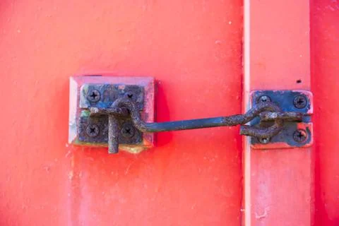 Door security latch metal hook on red door Stock Photos