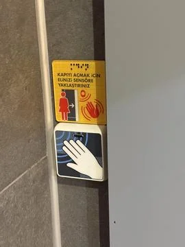 Door sensor panel with hand symbol and warning sign for an automated entry .. Stock Photos