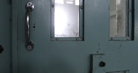 Door of solitary confinement cell opening with sound Stock Footage 90564325