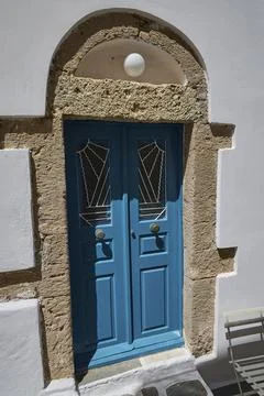Door in a stone arch frame, painted blue with decorative patterns, Plaka, main Stock Photos