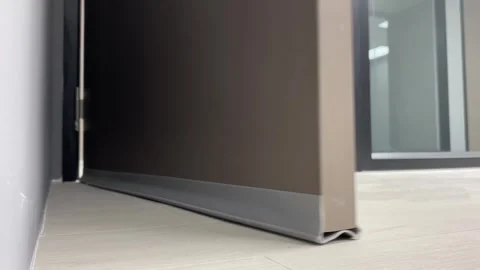 Door stopper for noice reduction low angle view open and close brown door indoor Video stock 248676402