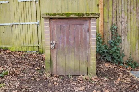 Door for a underground path in the woods Stock Photos