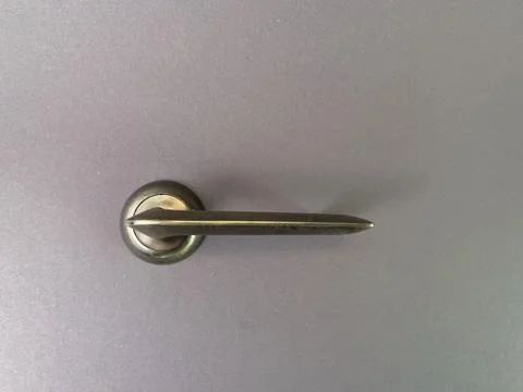 Doorknob on a gray background. Concept: exit, open the door. Stock Photos