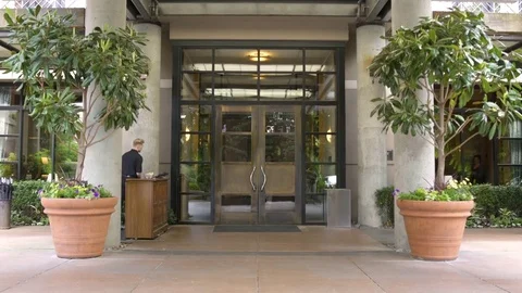 Doorman opening door for guests Video stock 83392459