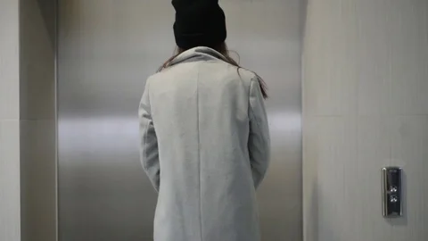 The doors to the Elevator opened, a woman Stock Footage 77180047