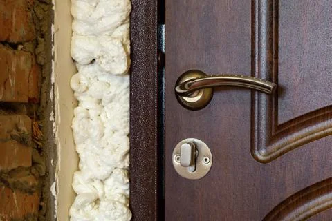 Doors installed in a brick wall with mounting foam Stock Photos