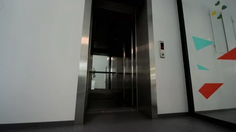 The doors of the office elevator close. The passenger elevator is empty without Video stock 157363669