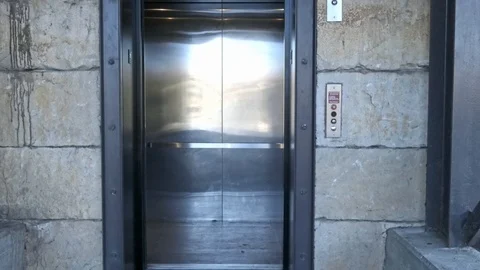 Doors opening and closing on carpark elevator with camera zooming in Stock Footage 102447198