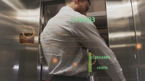 Doors opening, man entering elevator, adjusting bag while reading AR finance 库存影片 332542939