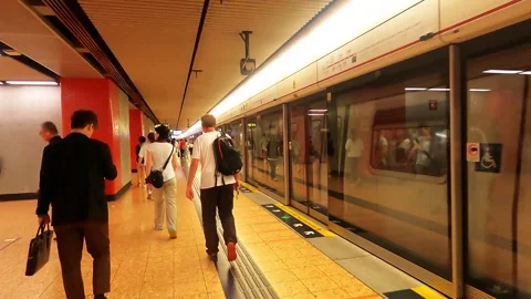 The doors on the subway trains are closing, and people are walking to the Stock Footage 341997257