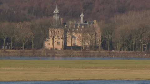 Doorwerth medieval castle alongside the river Rhine, migrating geese in front Stock Footage 58809474