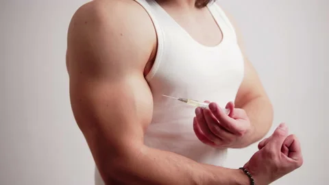Doping concept. Young caucasian man in a tank top cheating by using doping Stock Footage 175200834