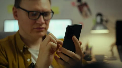 In a dorm room, a young technical school student spends his free time lookin Video stock 282651362