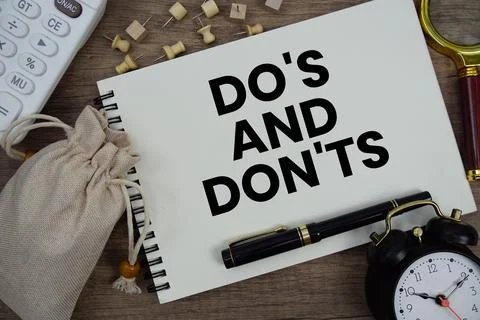 Do's And Don'ts text written on notepad with pen, alarm clock, magnifying g.. Stock Photos