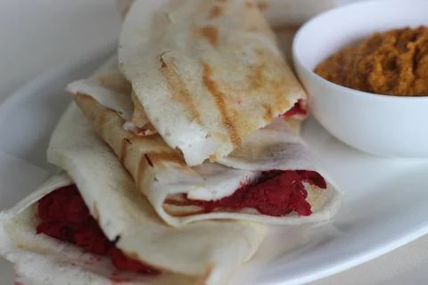 Dosa rolls with beetroot masala inside. Locally known as beetroot masala dosa Stock Photos
