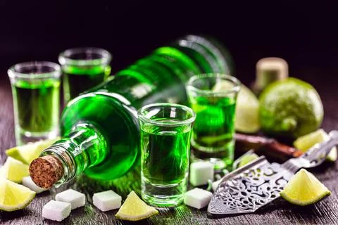 Doses of absinthe with brown sugar cubes. distillate of absinthe in a glass a Stock Photos