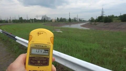 Dosimeter shows level of radiation viewing the Chernobyl NPP in the backgroun Stock Footage 114602632