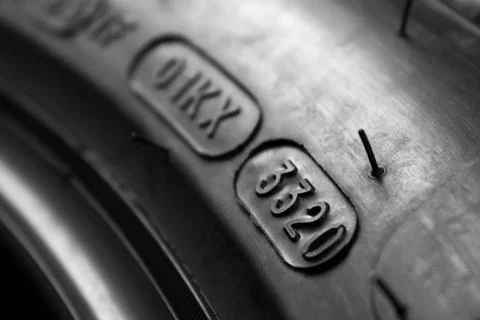 Dot code and date of production of the tire on the sidewall of the wheel. Clo Stock Photos