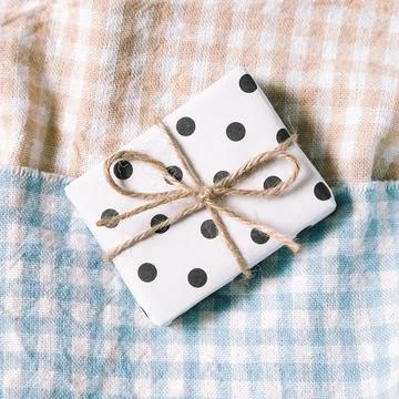 Dot pattern gift on check pattern fabric background Stock Photos