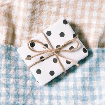 Dot pattern gift on check pattern fabric background Dot pattern gift on ch... Stock Photos