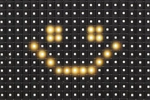 Dots matrix led diplay panel with illuminated symbol of smile face Stock Photos