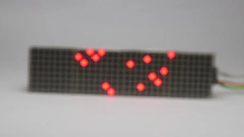 Dots on a red led matrix display module that shows the concept of data flow Stock Footage 327978414