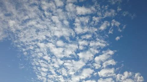 Dotted Cloud Formations in a Blue Sky 写真素材