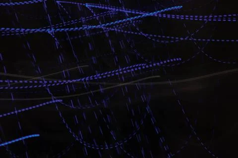Dotted lights line blue neon on dark background. Stock Photos
