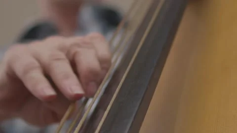 Double Bass Close Up Hand Picks String Then Slaps Neck Slow Motion Video stock 205580459