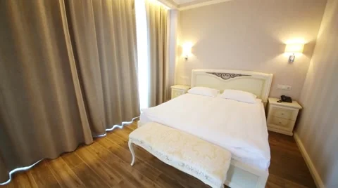 Double bed and bedside tables in a hotel room in El Paraiso Hotel Video stock 53234351