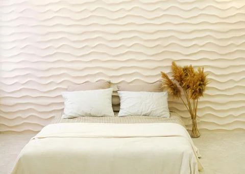 Double bed in the bedroom interior made in warm colors and smooth lines Stock Photos