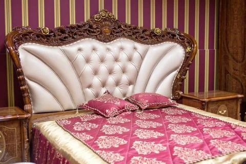 Double bed with decorative headboard Stock Photos