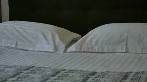 Double bed in the hotel room. Double bed with white bed linen. Stock Footage 106992115