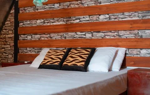 Double bed inside the cabana, white and clean sheets, soft pillows, luxury li Stock Photos