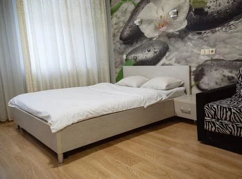 Double bed with pillows and light from the window. Stock Photos