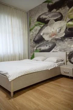 Double bed with pillows and light from the window. Stock Photos