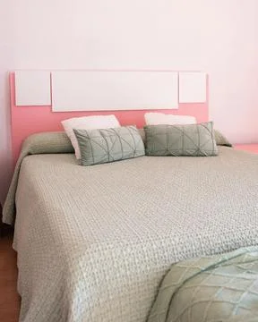 Double bed with pillows in interior of the modern bedroom Stock Photos