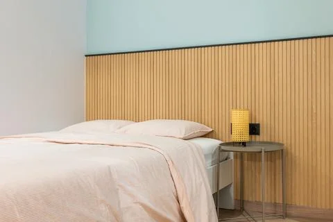 Double bed with pillows is made up with large warm duvet and linens in pleasant Photos