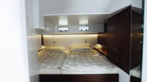 Double Berth With White Bedding Forward Yacht Cabin, Luxury Bedroom, Wide Shot Stock Footage 340336147