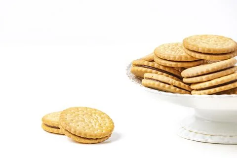 Double biscuits in and next to white bowl white background copy space Stock Photos