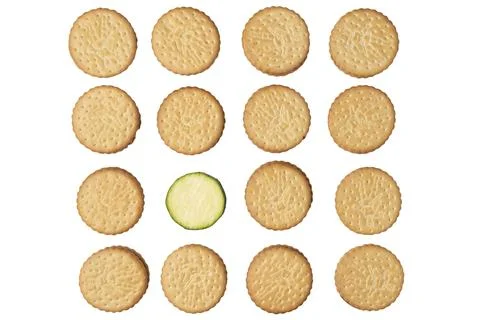 Double biscuits in rows with a courgette slice Cucurbita pepo on white Фото